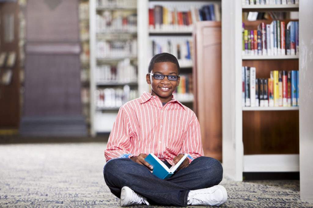 Boy reading in library
